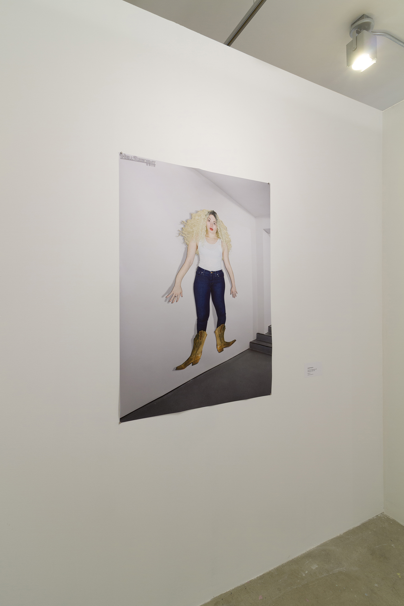 A print of a girl stylisticily flattened hung on a white wall